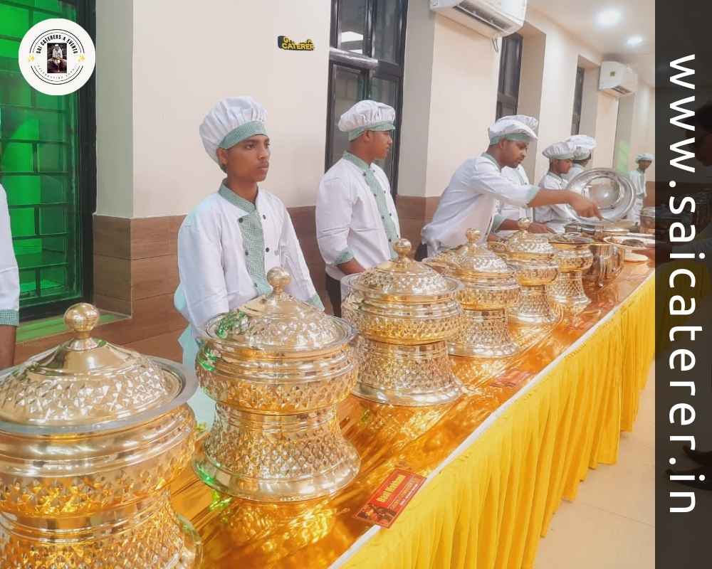 Staff in white uniform serving food at golden buffet