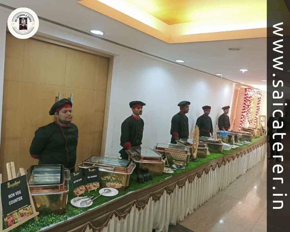 Wedding catering staff in black dress at decorated counter
