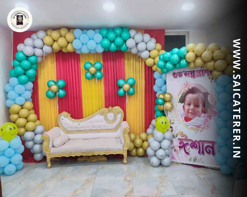Bengali annaprashan venue with baby Ishan photo and balloon décor
