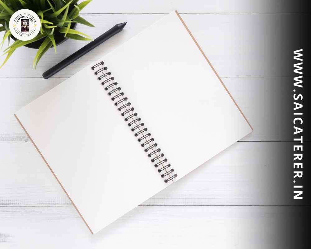 White notebook placed on table for catering planning