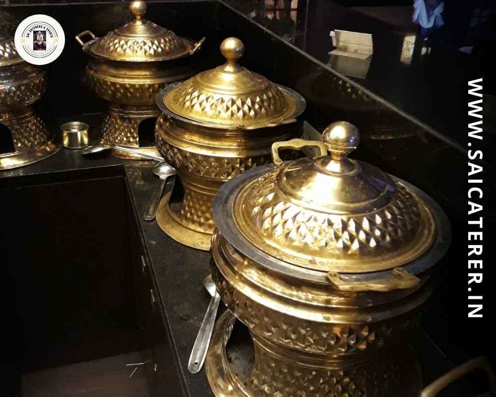Golden buffet setup with Bengali fish and prawn dishes