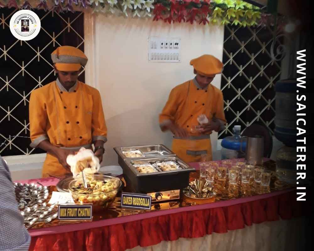 Catering staff in orange uniform at family kitty party in Santragachi Kolkata