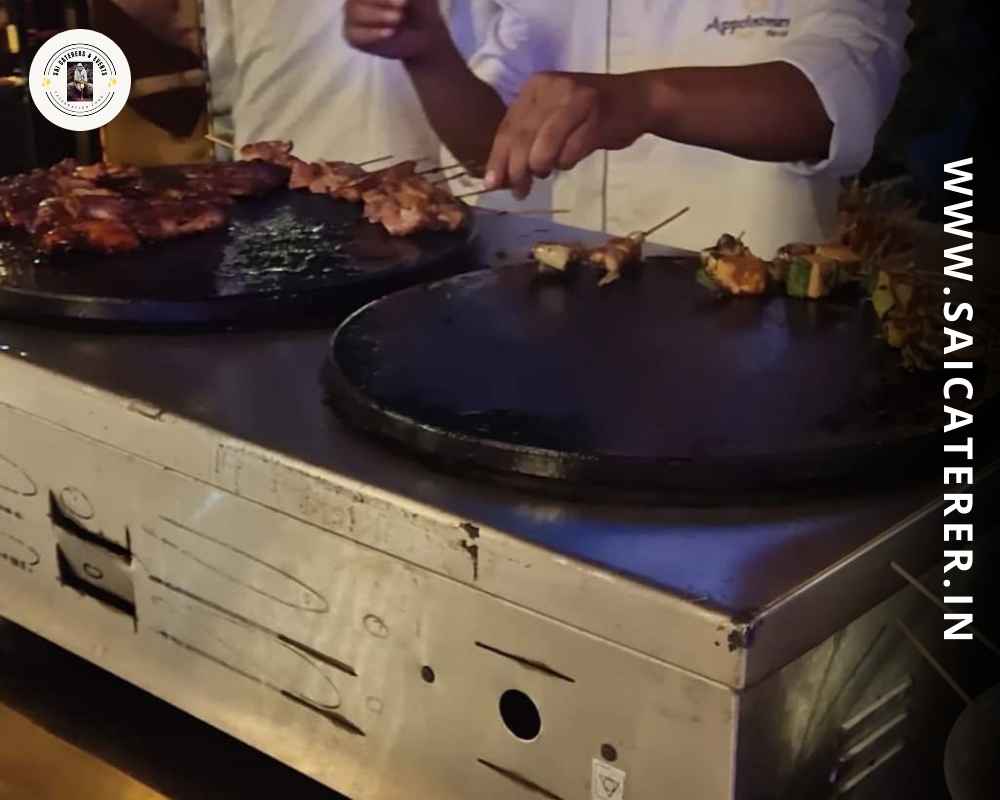 Chef preparing paneer tikka at live cooking counter with care
