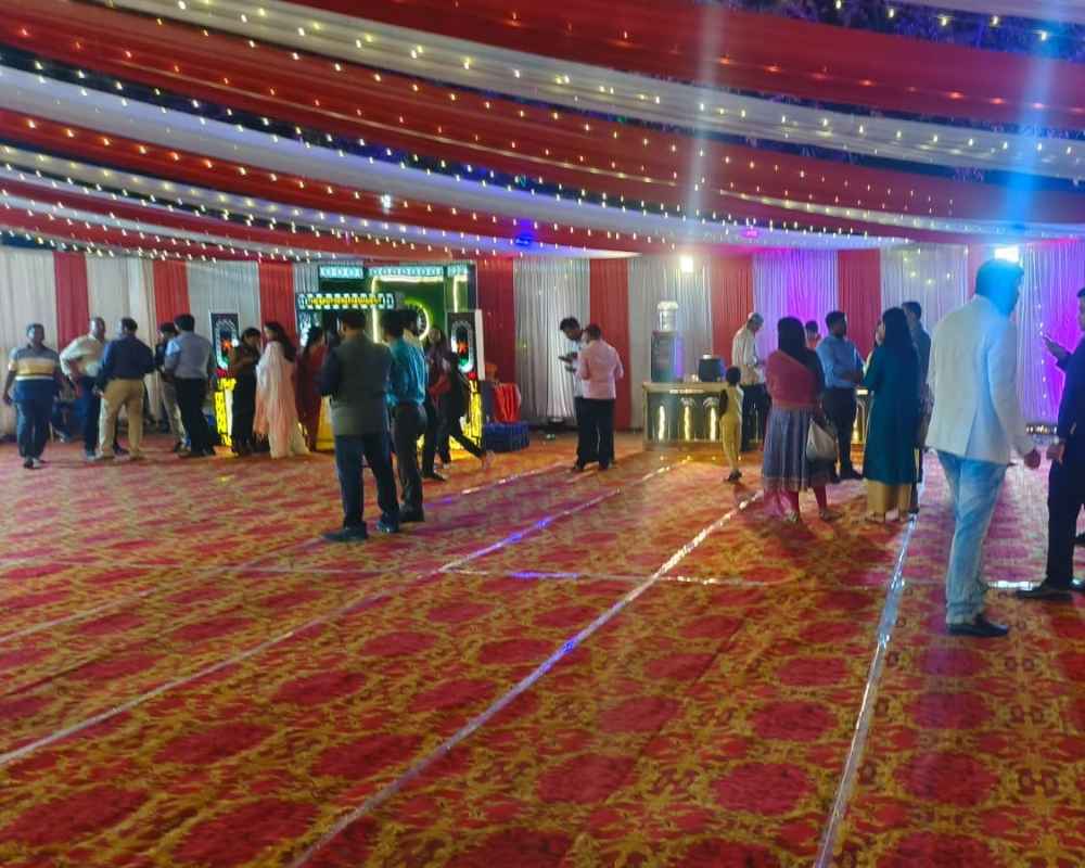 Outdoor reception catering with pandal and guests enjoying food in Baranagar